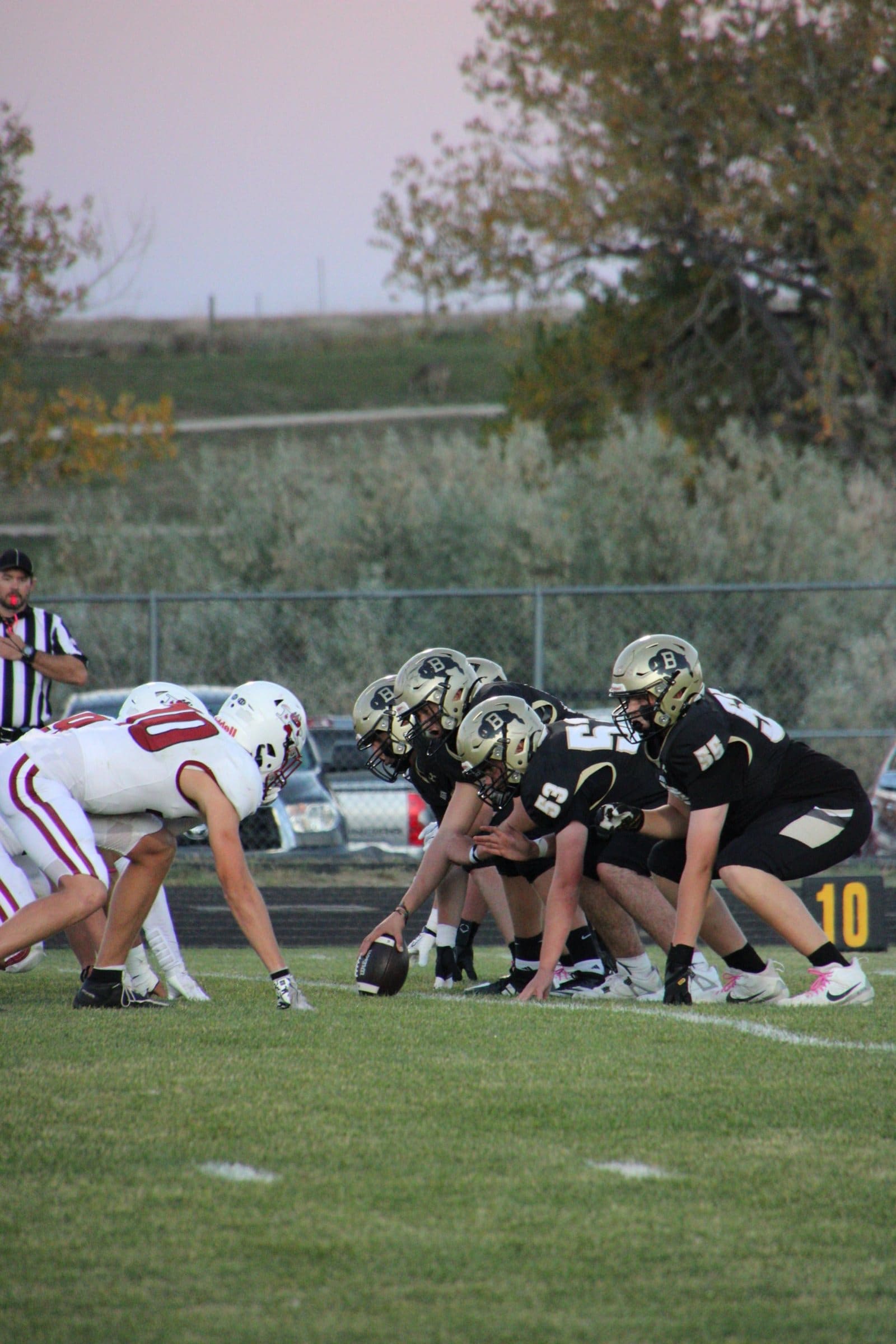 Offensive and defensive linemen set at the line of scrimmage before the snap